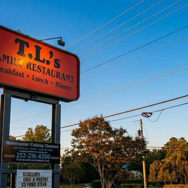 A red and orange sign for T.L.'s Family Restaurant, advertising breakfast, lunch, and dinner.